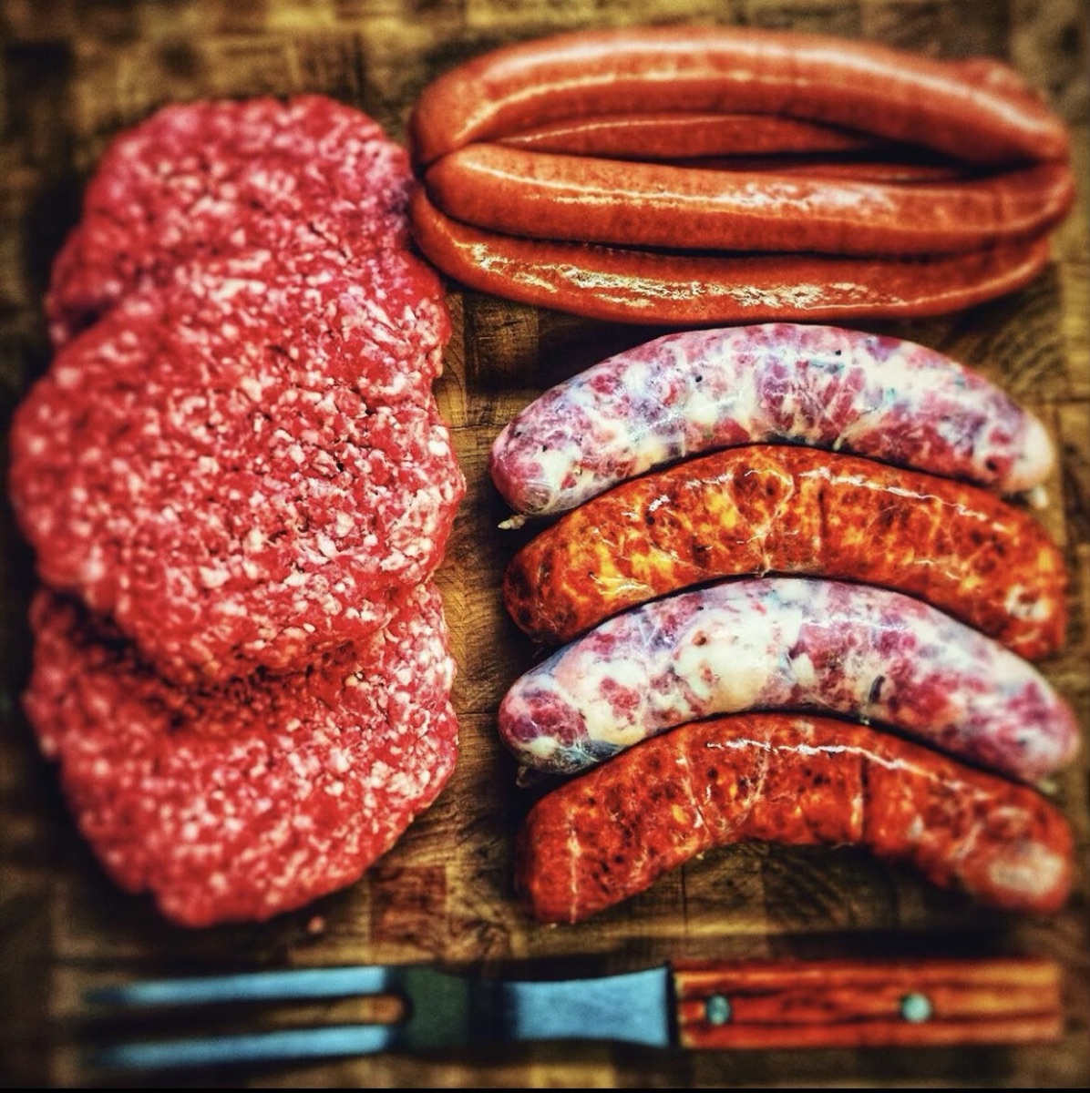 The BVMM Grill Bundle — hand-made patties and sausages laid out ready for the grill